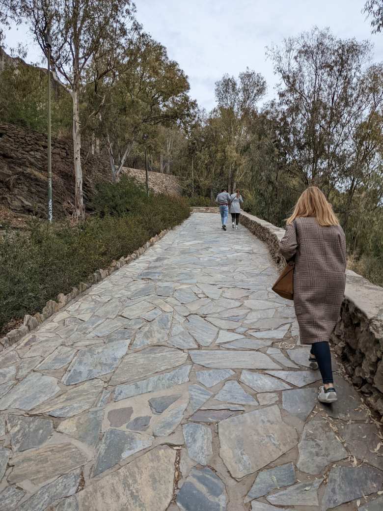 Andrea walking up a ramp to the Alcazaba.
