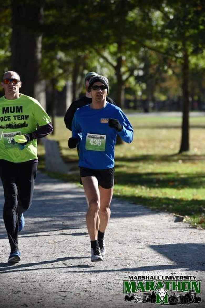 Felix Wong running next to Nick, the 3:30 pacer, at the 2019 Marshall University Marathon.