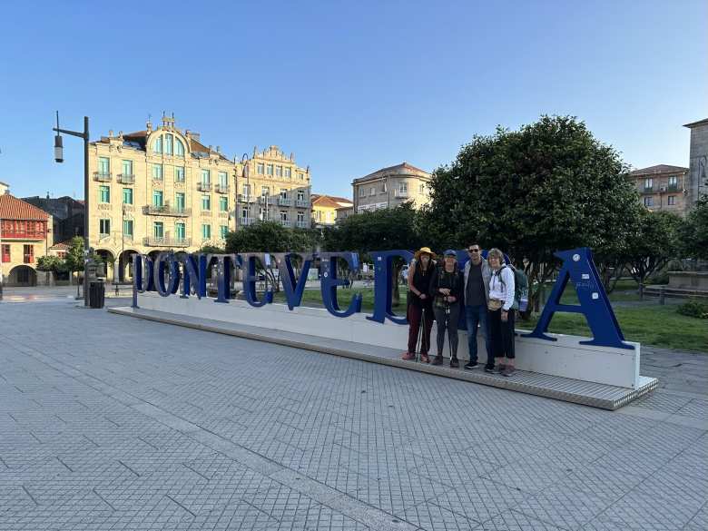 Amelia, Jeri, Felix, and Marsanne, in front of the Pontevedra sign in the city center.