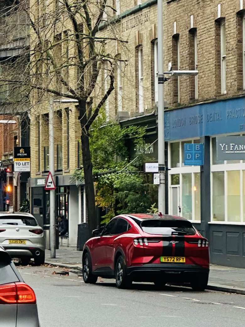 One inspiration for getting my EV: a Rapid Red Mustang Mach-E with racing stripes in London. This one didn't have the panoramic glass roof.