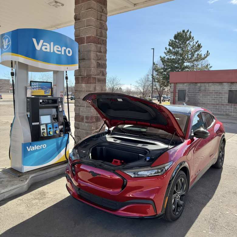 Meter Mackenzie getting gas at a gas station—but for my gas-powered car.