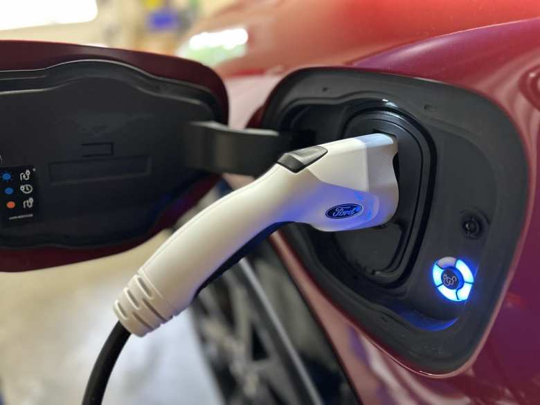 Plugging in the Ford J1772 110V AC slow charger in the garage is a cinch.