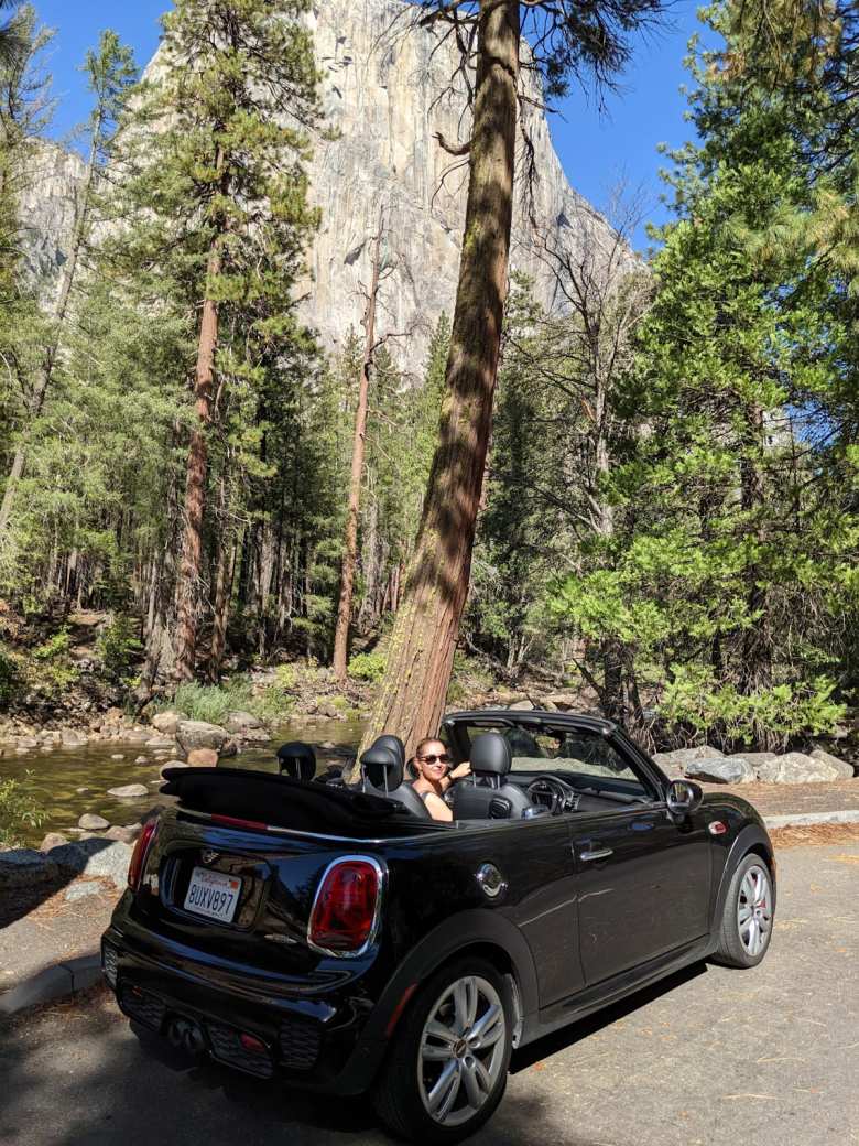 Andrea in the MINI Convertible in front of the Merced River and El Capitán.