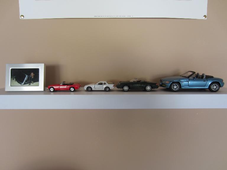 The models of cars I had, now on a shelf in the garage.  I still need one to represent Goldie, my 1969 pale primrose MGB.  I also don't have an Audi TT model, but I have the real thing in the garage!