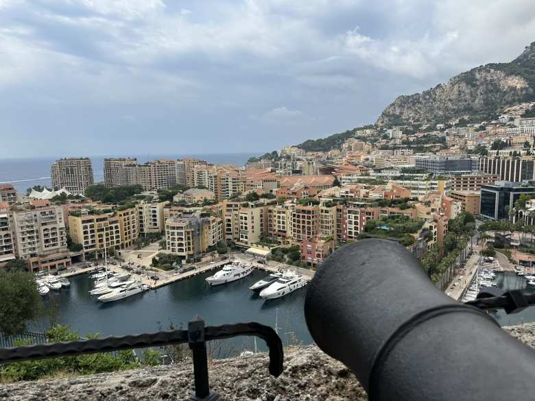 A cannon pointed towards the yachts and apartment buildings at the Port of Fontvieille.