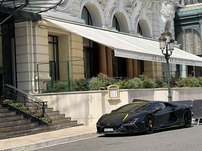 A black Lamborghini the Hotel de Paris in Monaco.