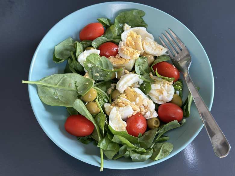 Salads I made for daily breakfasts with spinach, hard-boiled eggs, tomatoes, olives, olive oil, and balsamic vinegar.