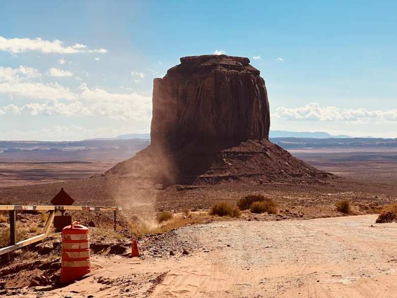 A mini-tornado formed right in front of us next to the dirt road that descends into Monument Valley. Merrick Butte is the butte in the photo.