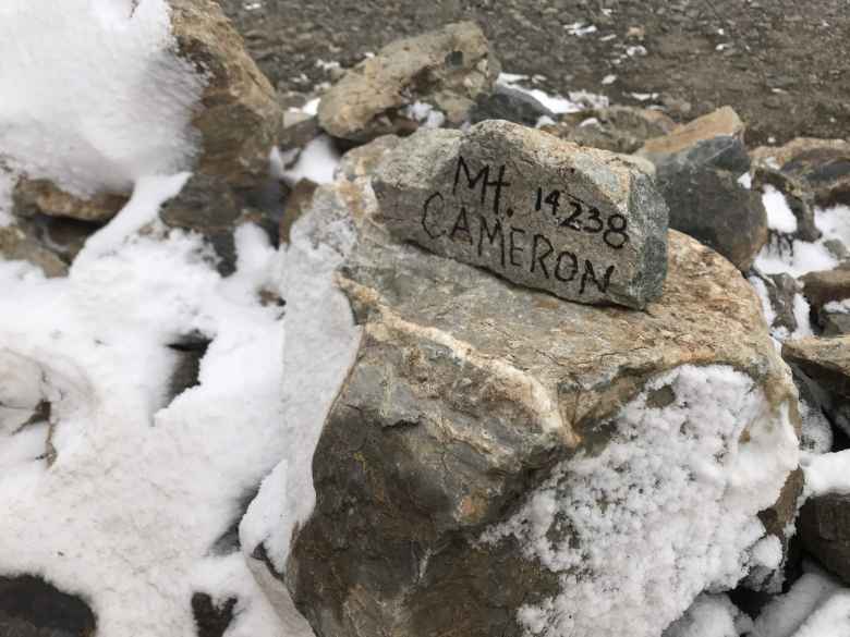 Stone proclaiming the top of Mt. Cameron at 14238 feet.