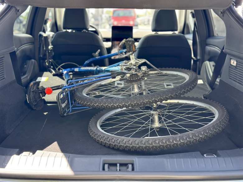 With the rear seats folded down, my Raleigh M-30 mountain bike easily fit inside Mustang Mach-E rental car. I removed the front wheel, but with some finagling, it may have been possible to leave the front wheel on.