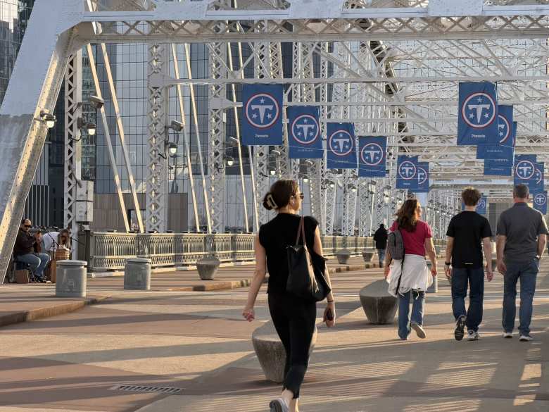 The John Seigenthaler Pedestrian Bridge crosses the Cumberland River over to the Nissan Stadium. There was a couple getting ready to play music on it.