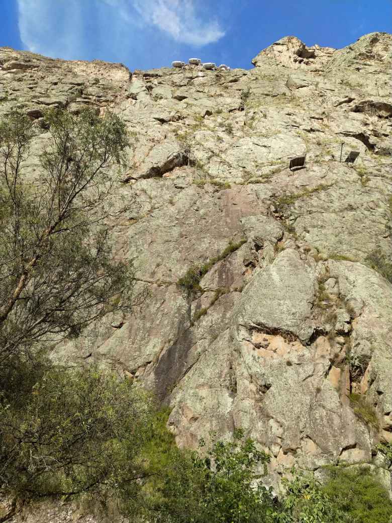 At the very top of this cliff are three pods that we climbed to via ferrata. The cliff was about 1200 feet in height.