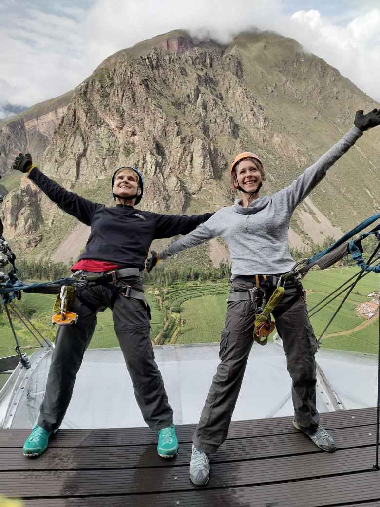 Mel and Teresa on top of the pod with the Sacred Valley below.