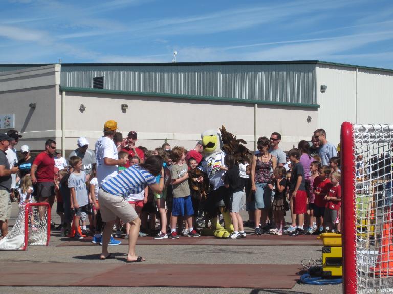 Lining up for the free kids run with the Colorado Eagles mascot in the center. Lining up for the free kids run with the Colorado Eagles mascot in the center.