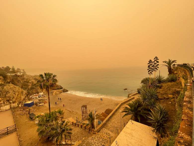 There was lots of calima (haze) in the air from the sands in the Sahara Desert of Africa, causing the sky to be orange. It would later rain mud.