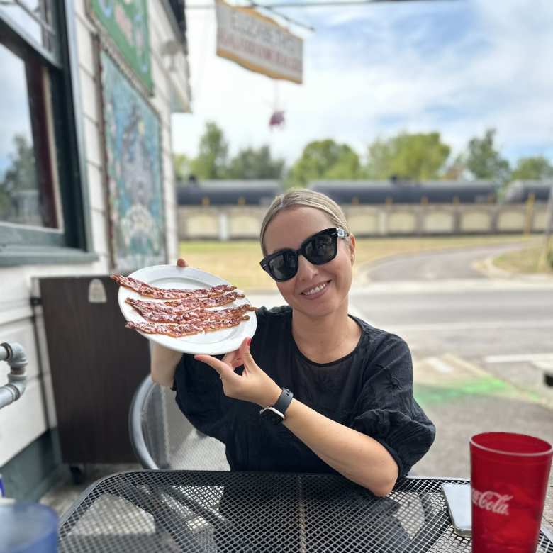 Andrea with a Spain sign on the sidewalk.