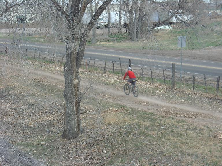 Lone mountain biker on a flat stretch.