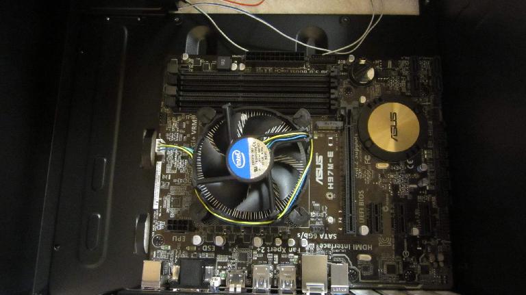 The CPU and fan installed on the motherboard, which in turn is installed in the case.