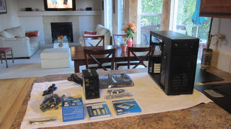 Laying out all the computer parts on a towel on the kitchen tabletop.