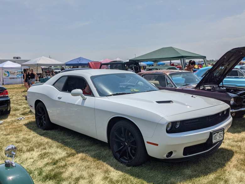 A white Dodge Challenger with black wheels.