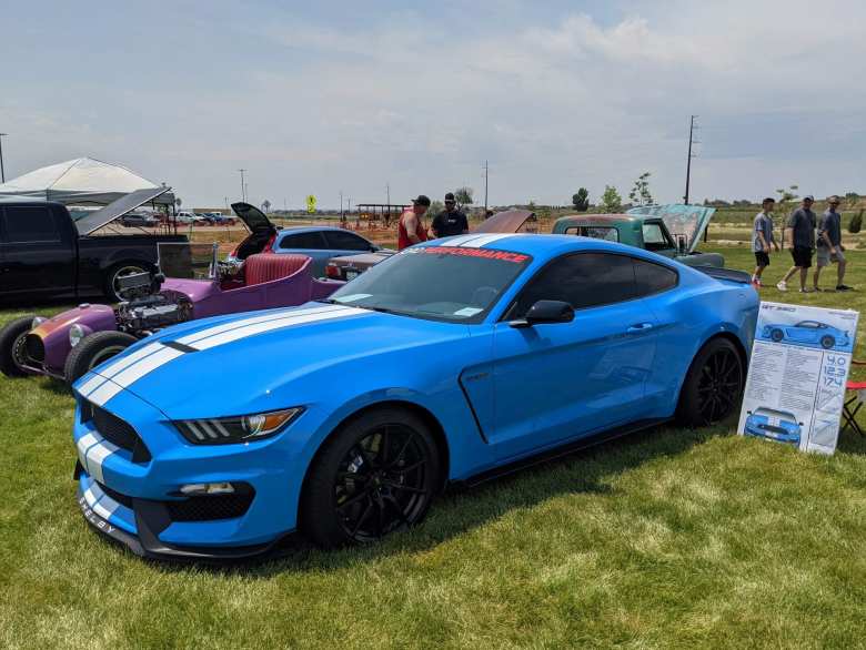 A bright blue Ford Mustang Shelby GT350.