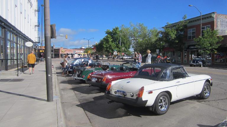 white rubber-bumpered MGB roadster with top up, British sports cars, downtown Fort Collins