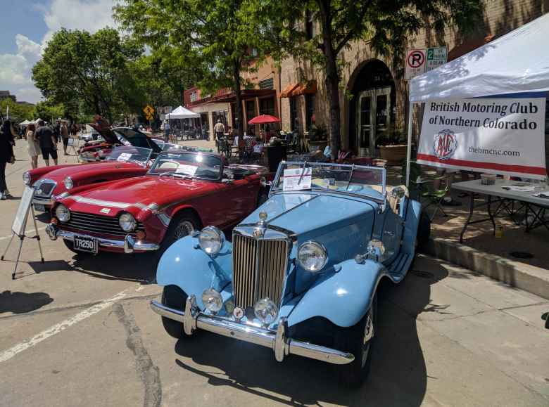 A red MGA, red Triumph TR250, and light blue MG TD.