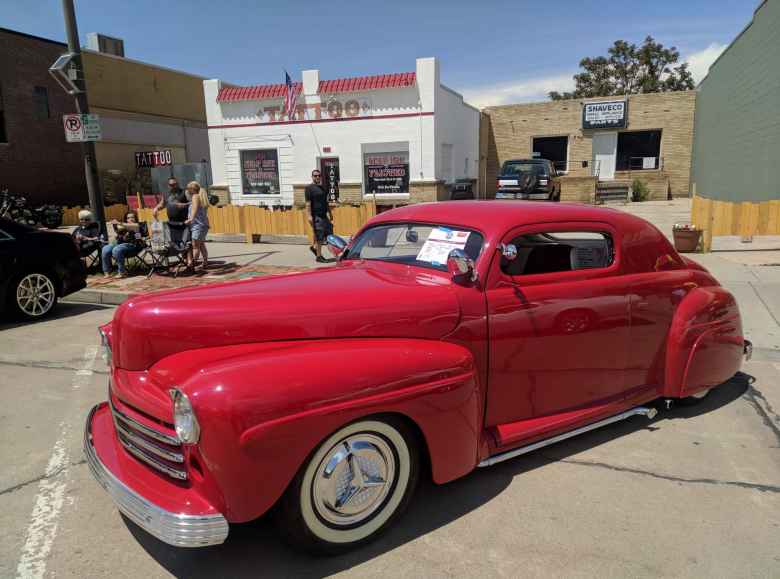 A red 1947 Ford coupe hot rod.