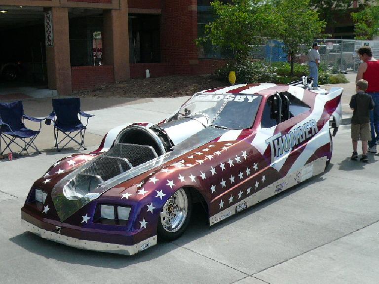 A drag racing car replete with a rocket engine.