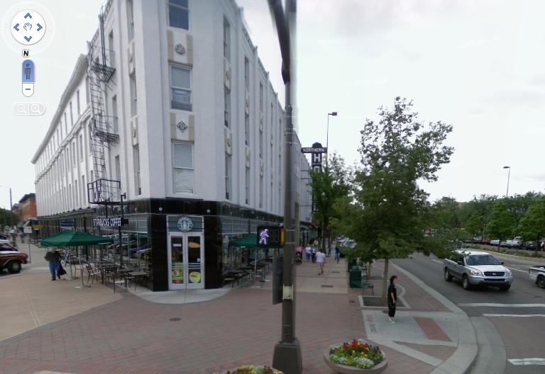 white three-story angular building on corner of College Avenue and Walnut Street in Fort Collins.