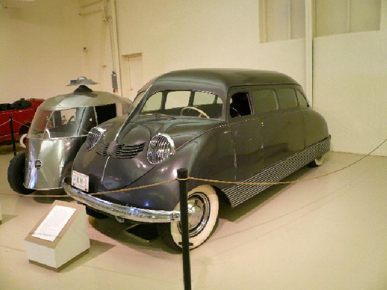 The 1935 Stout Scarab had a rear Ford V-8 producing 200 hp.  Only nine were built.