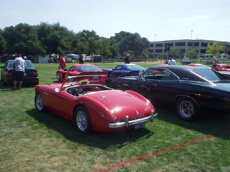 The Austin Healey is fairly large for a British sports car, but looks rather small next to a Dodge Charger.