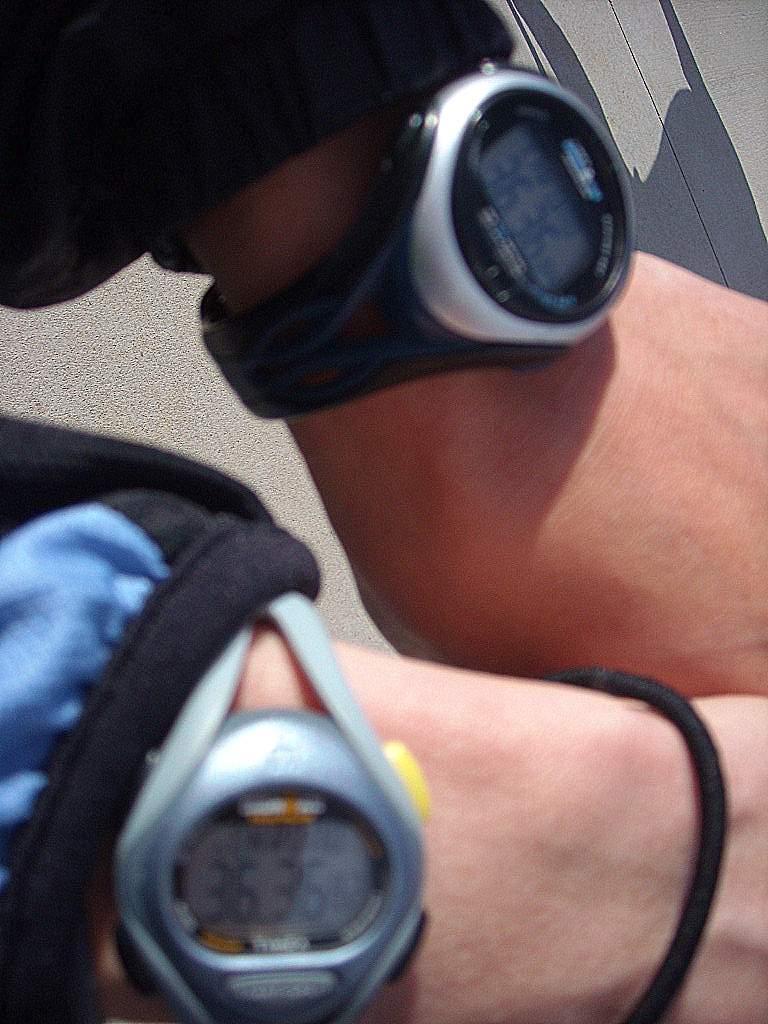 Timex Ironman watches on two different runners' wrists, one with a time of 36:36.82 and the other with 36:36.84.