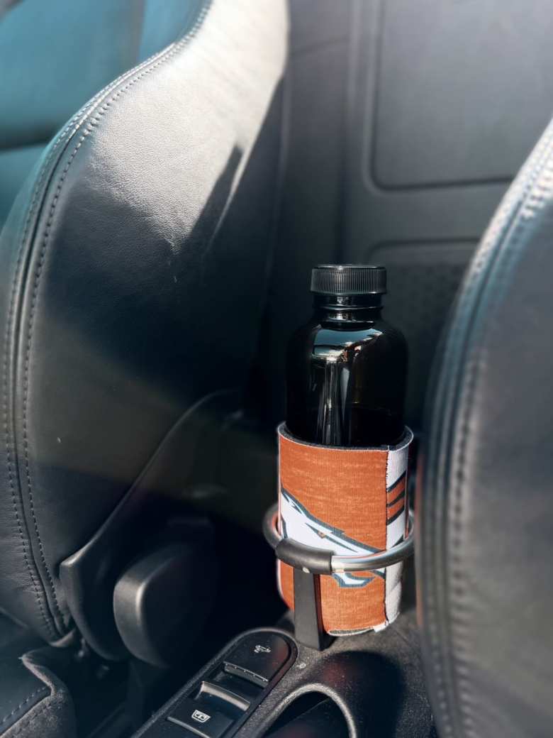 The kombucha bottle with Broncos koozie in my Audi TT's cupholder.