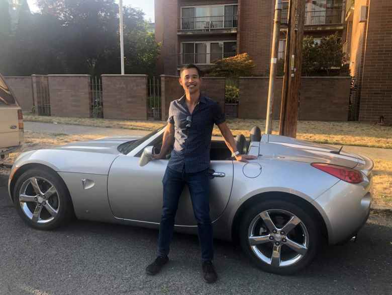Felix Wong with the silver Pontiac Solstice GXP he rented in the Pacific Northwest.