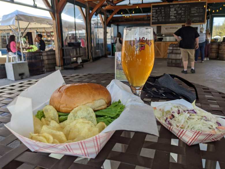 burger, chips, coleslaw, and beer at Allagash Brewing Company