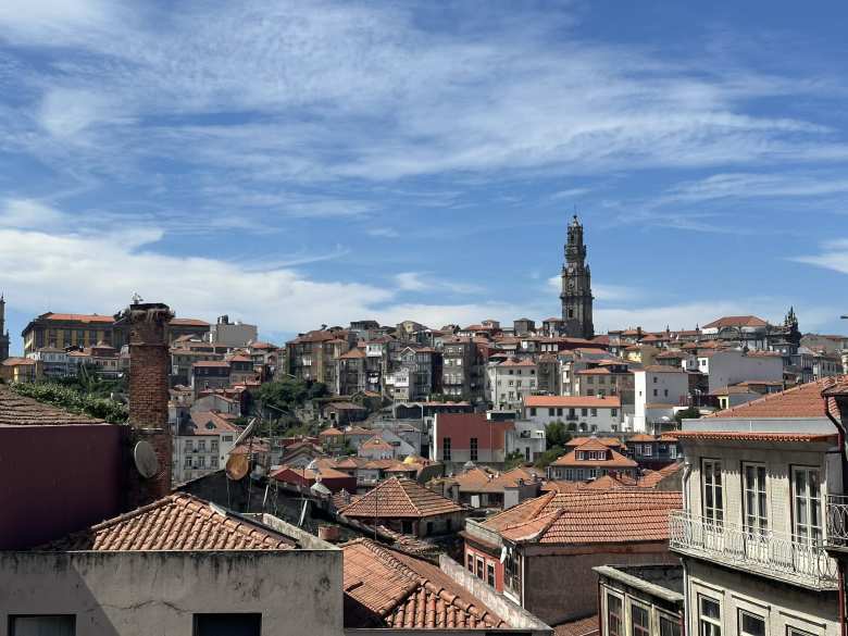 Ther Clerigos Tower above red tile roofs in Porto.