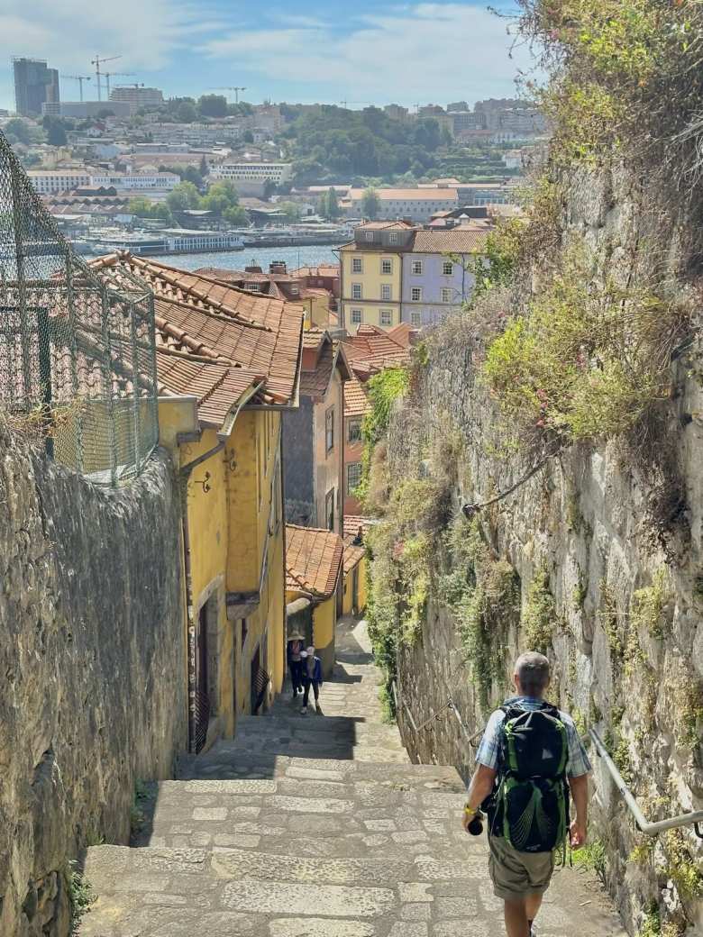 Eddie walking down steps towards the Douro River in Porto.