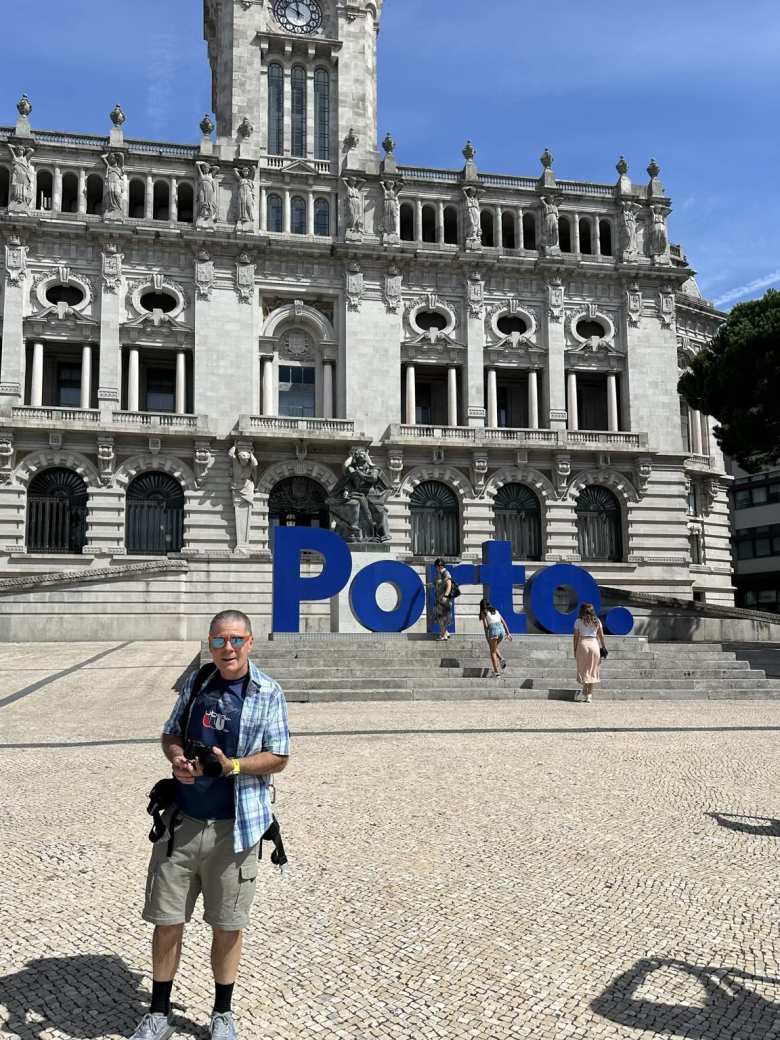 Eddie in front of the Porto sign at City Hall.