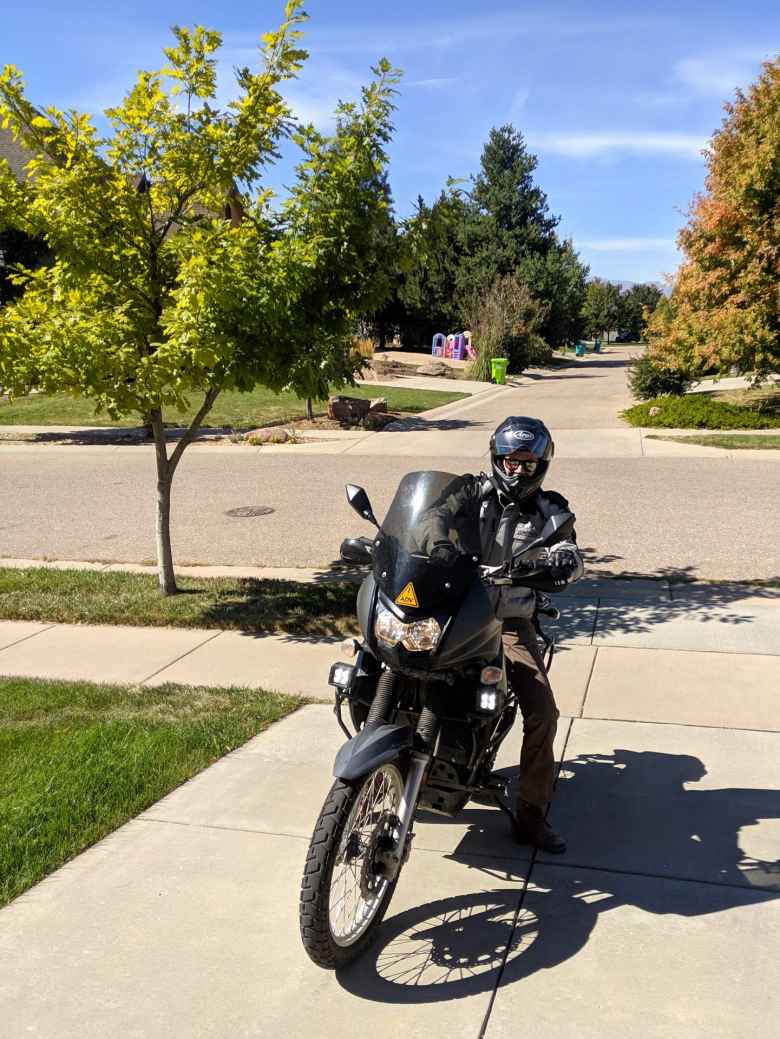 Alex arrives at my house on his black Kawasaki KLR 650.