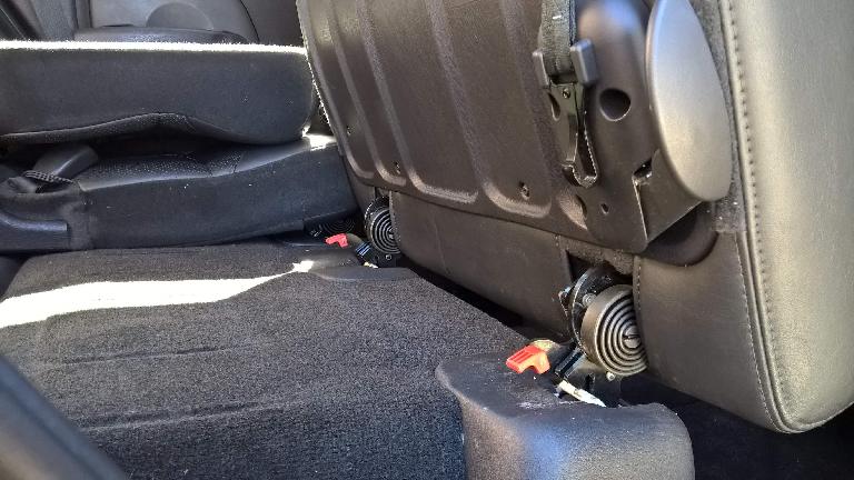 Detail of the latches holding the removable rear seats down to the floor.
