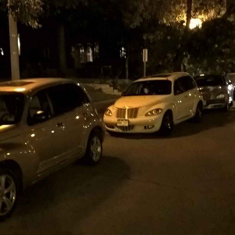 Three PT Cruisers in Central West End in St. Louis at night.