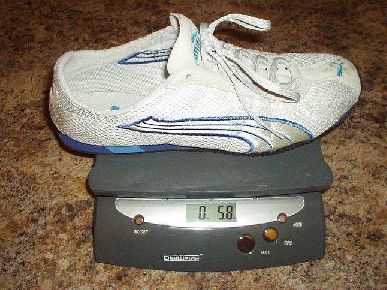 white and blue Puma H-Street shoe on postal scale reading 5.8 ounces