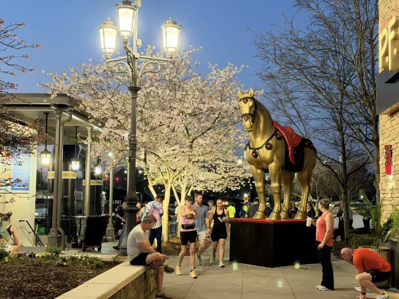 A horse statue and cherry blossoms at Bridge Street Town Centre.