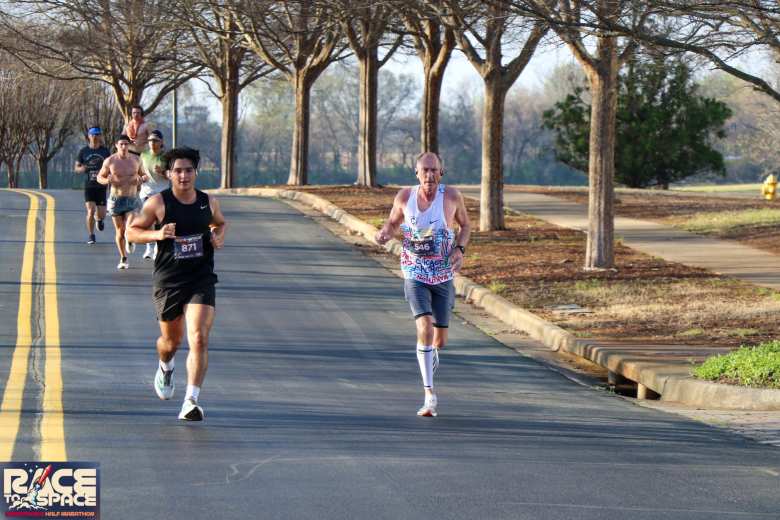 Running down a hill through Cummings Research Park during the Race to Space Marathon. You can see me at the very left.