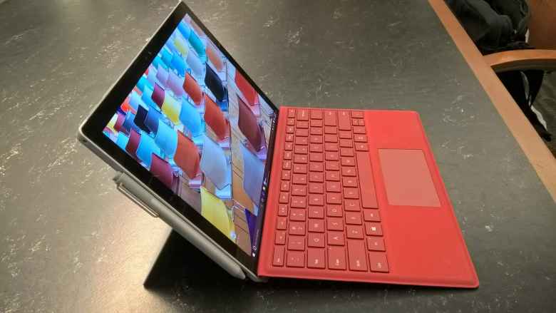 red Microsoft Surface Pro 4 with stylus