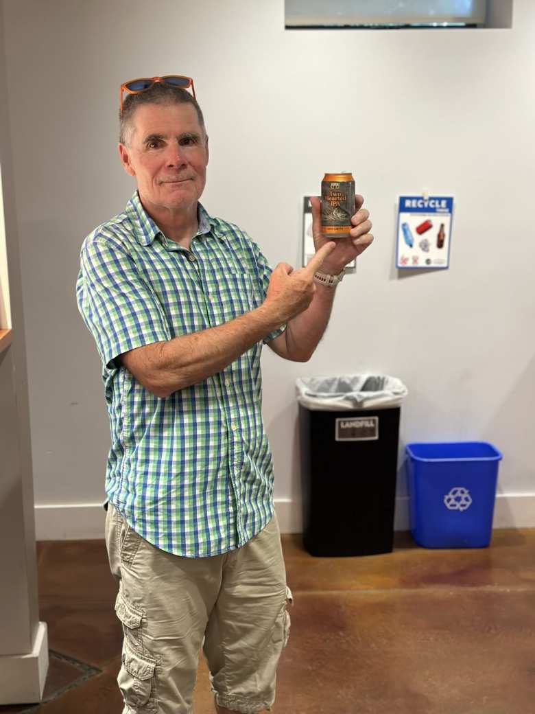 Eddie Metro holding a can of Two Hearted IPA at the Ride the Divide Returns Film Festival.