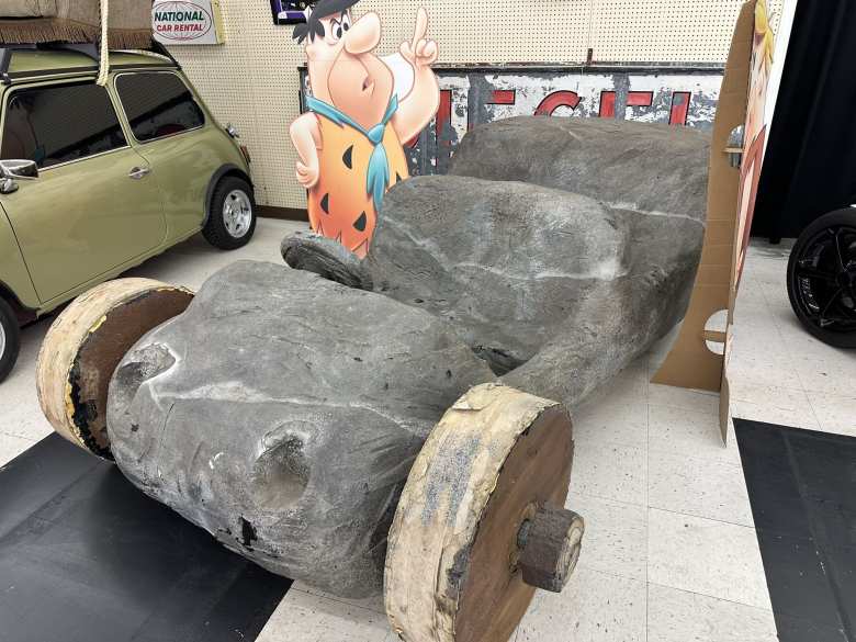 The Flintstones Rubble Racer from the 1994 Flintstones movie. In the background is the green 1997 Leyland Mini 1000 that was the car used in Mr. Bean. The Flintstones Rubble Racer from the 1994 Flintstones movie. In the background is the green 1997 Leyland Mini 1000 that was the car used in Mr. Bean.