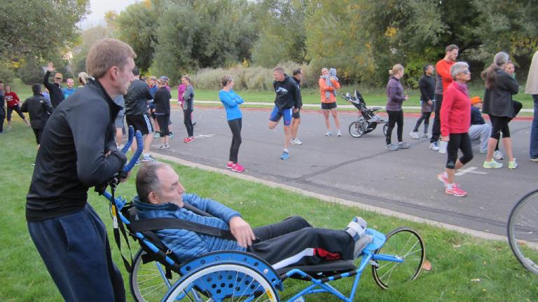 Scott pushing a guy in a stroller for Athletes in Tandem.