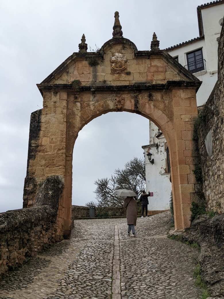 Andrea underneath an arch near the Puente Viejo in Ronda.
